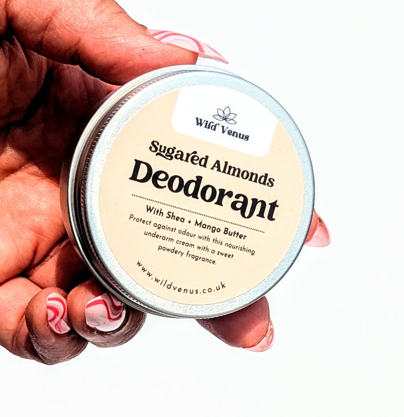 Holding a tin of Sugared Almonds scented deodorant cream.