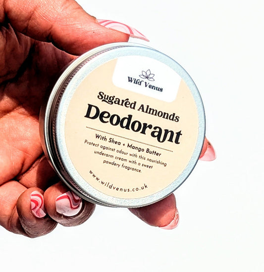 Holding a tin of Sugared Almonds scented deodorant cream.