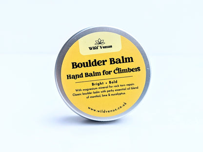 A tin of Boulder Balm Hand Balm for Climbers. The product is on its side with the top of the tin showing the label. The product is against a white label. 