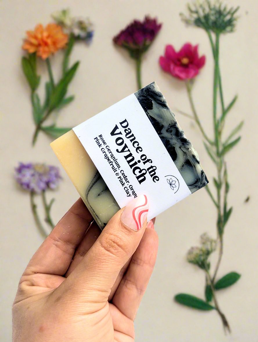 A dance of the voynich soap bar held in front of a table. 