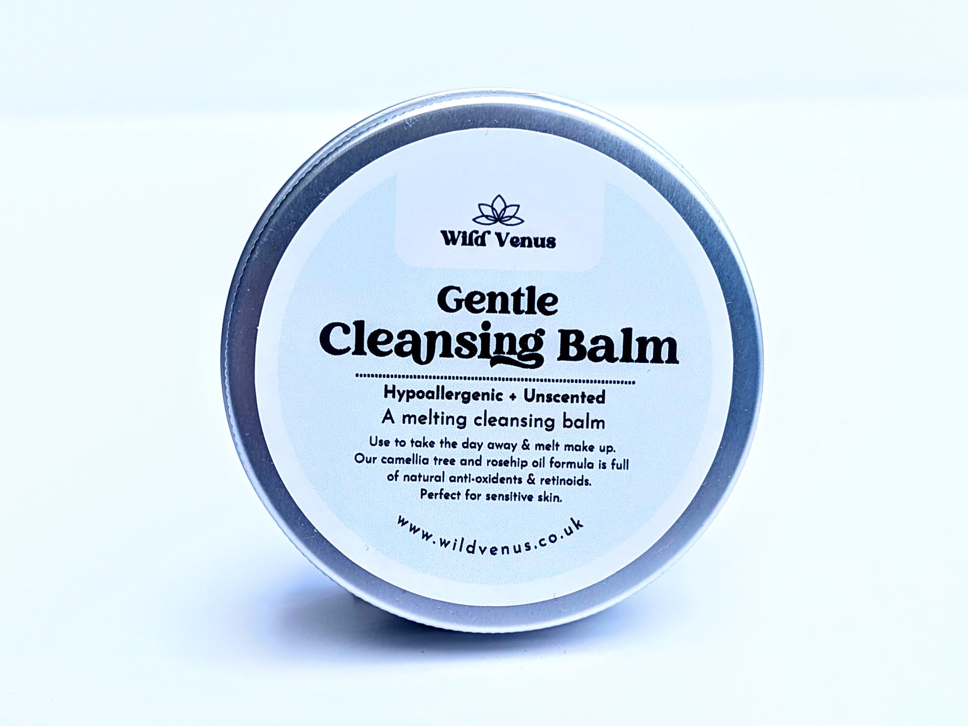 A tin of Gentle Cleansing Balm on its side with the front of the label showing. The product is against a plain white background. 