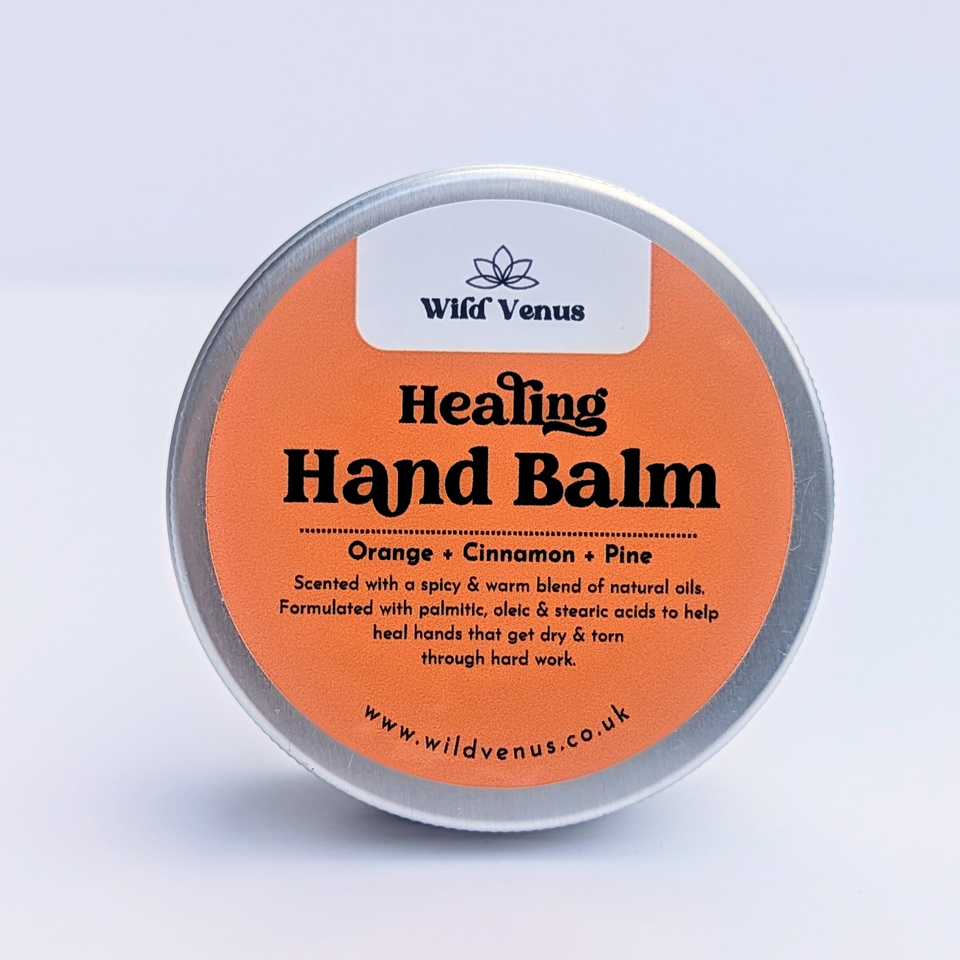 A tin of Healing Hand Balm is shown against a white background. 
