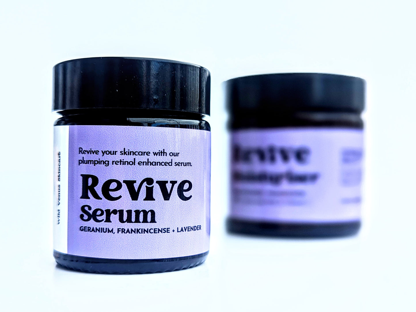 Revive serum is in the foreground and revive moisturiser is out of focus in the background. 