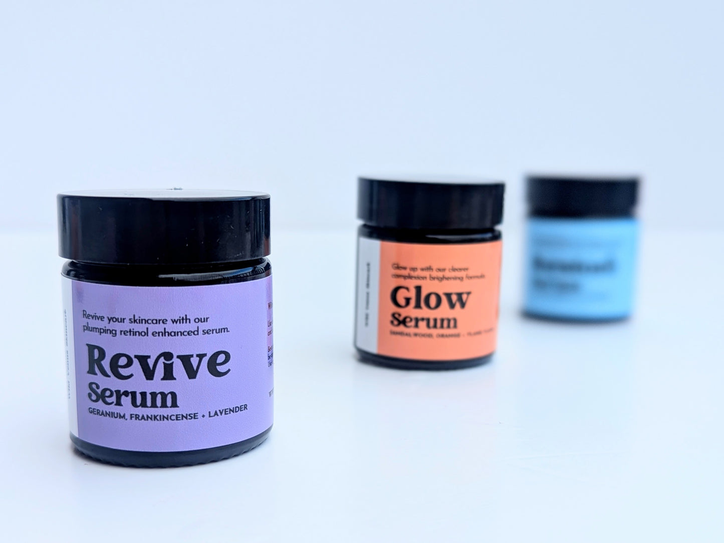 The revive serum is in the foreground with the Glow serum behind and then the Restore serum is at the back and very out of focus. 