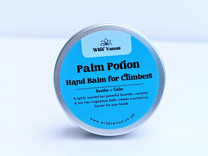 A tin of Palm Potion Hand Balm for CLimbers. The tin is on its side with the label facing the viewer against a plain white background. 