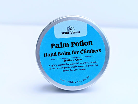 A tin of Palm Potion Hand Balm for CLimbers. The tin is on its side with the label facing the viewer against a plain white background. 