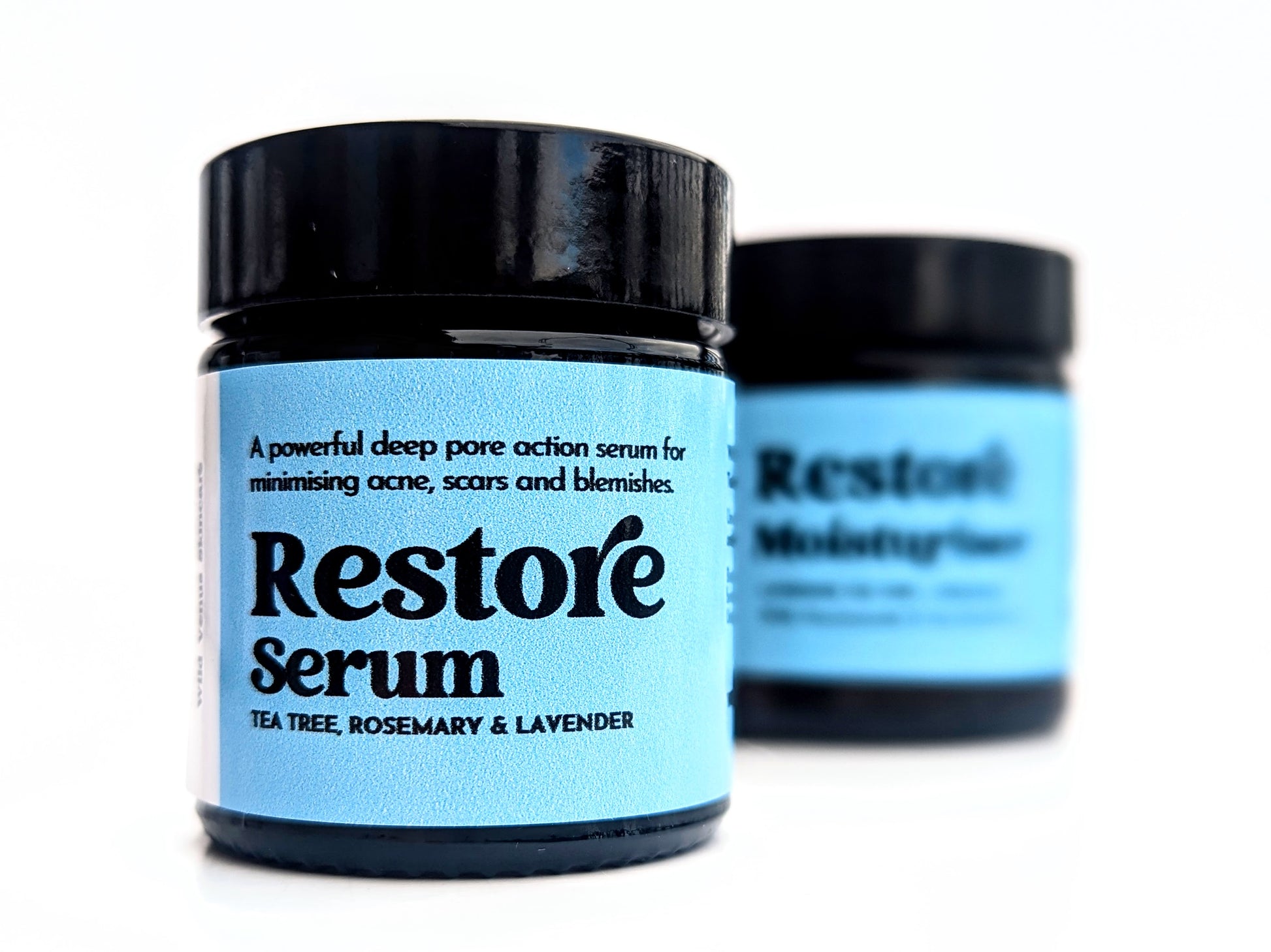 Restore serum with moisturiser behind. The products are against a white background. 