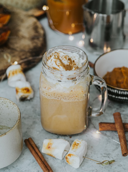 Delicious creamy latte with toasted marshmallows and cinnamon sticks. 