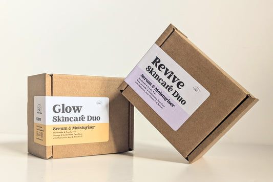 Two gift boxes are shown against a white background. The Glow box is shown at an angle to the camera but with the label clearly showing. The Revive box set is leaning up against the other box. Both labels describe what is inside the boxes. 