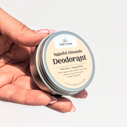 Holding a tin of Sugared Almonds scented deodorant cream.