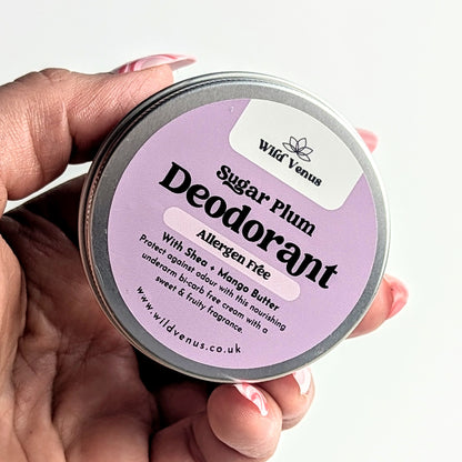 A close up of holding a tin of Sugar Plum sensitive deodorant. 