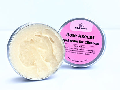 An open tin of Rose Ascent Hand Balm for Climbers. The tin is on its side with the balm facing the viewer against a plain white background. The tin lid is slightly tucked behind the tin and the label is facing the viewer. 