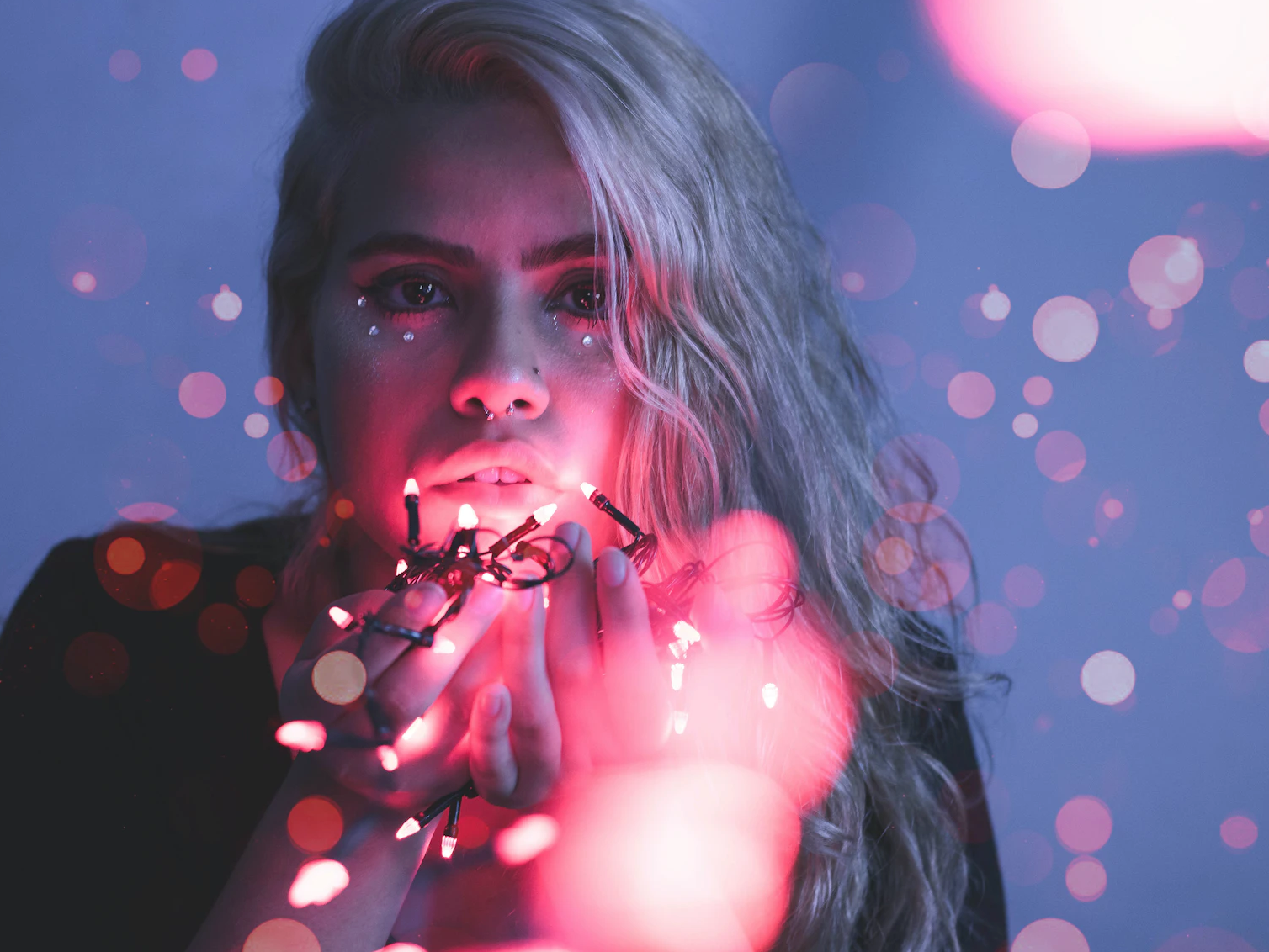 Woman holding fairy lights.