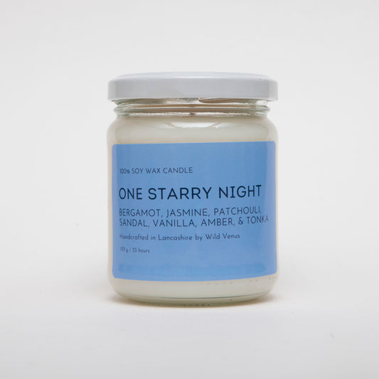 The One Starry Night Candle is a simple white candle with a bold label. The candle has scent notes of bergamot, jasmine, patchouli, sandal, vanilla, amber and tonka. 