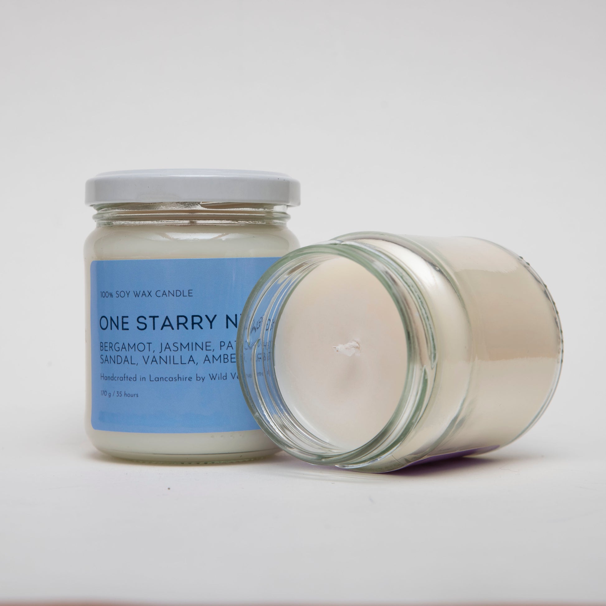 One jar of starry night is open to show the lovely smooth top made with natural soy wax. 